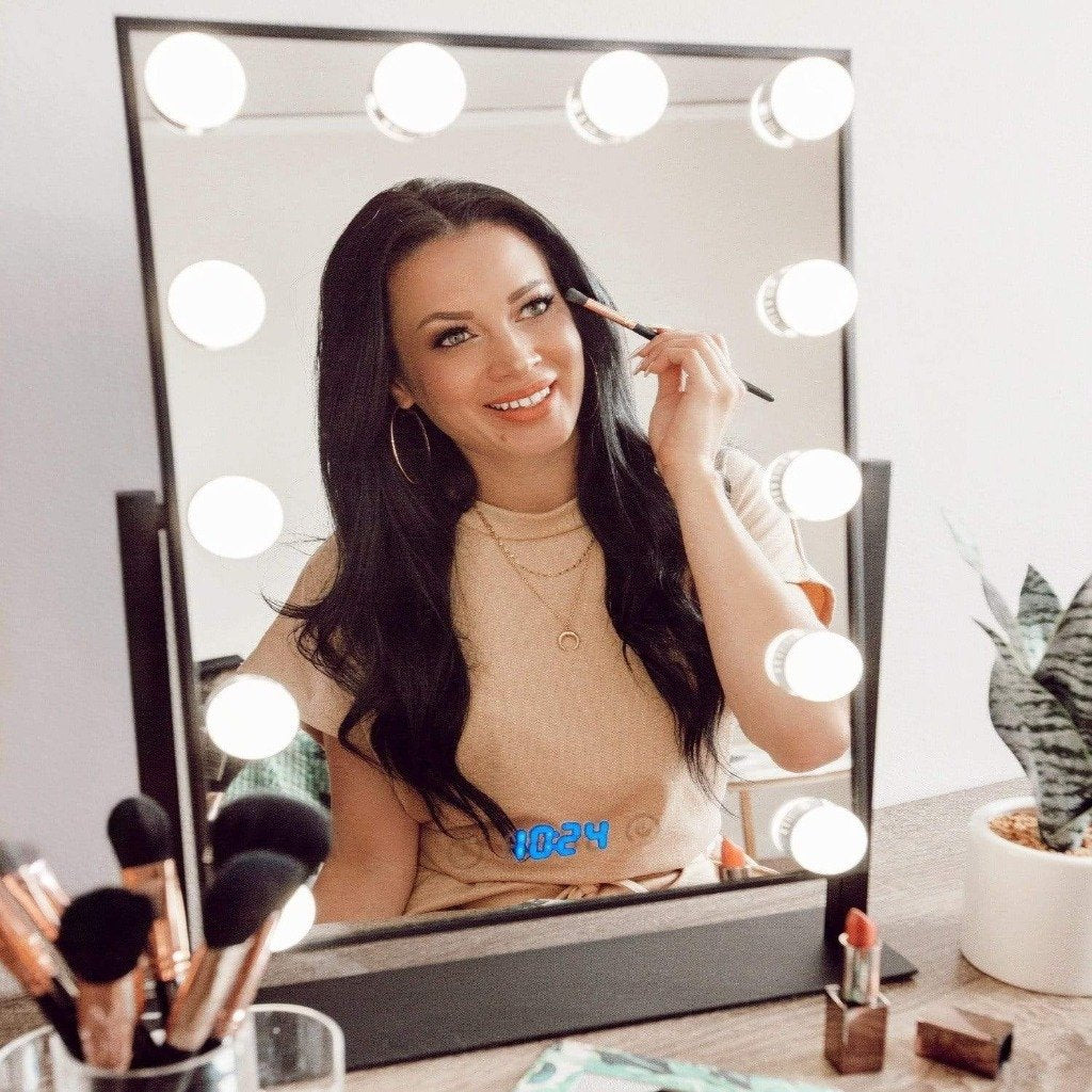 Black Hollywood vanity mirror with lights with model in front